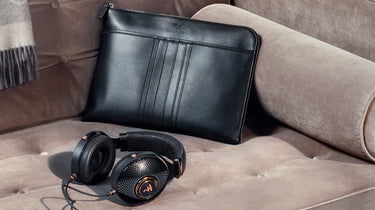 Bentley headphones on sofa with leather bag in background